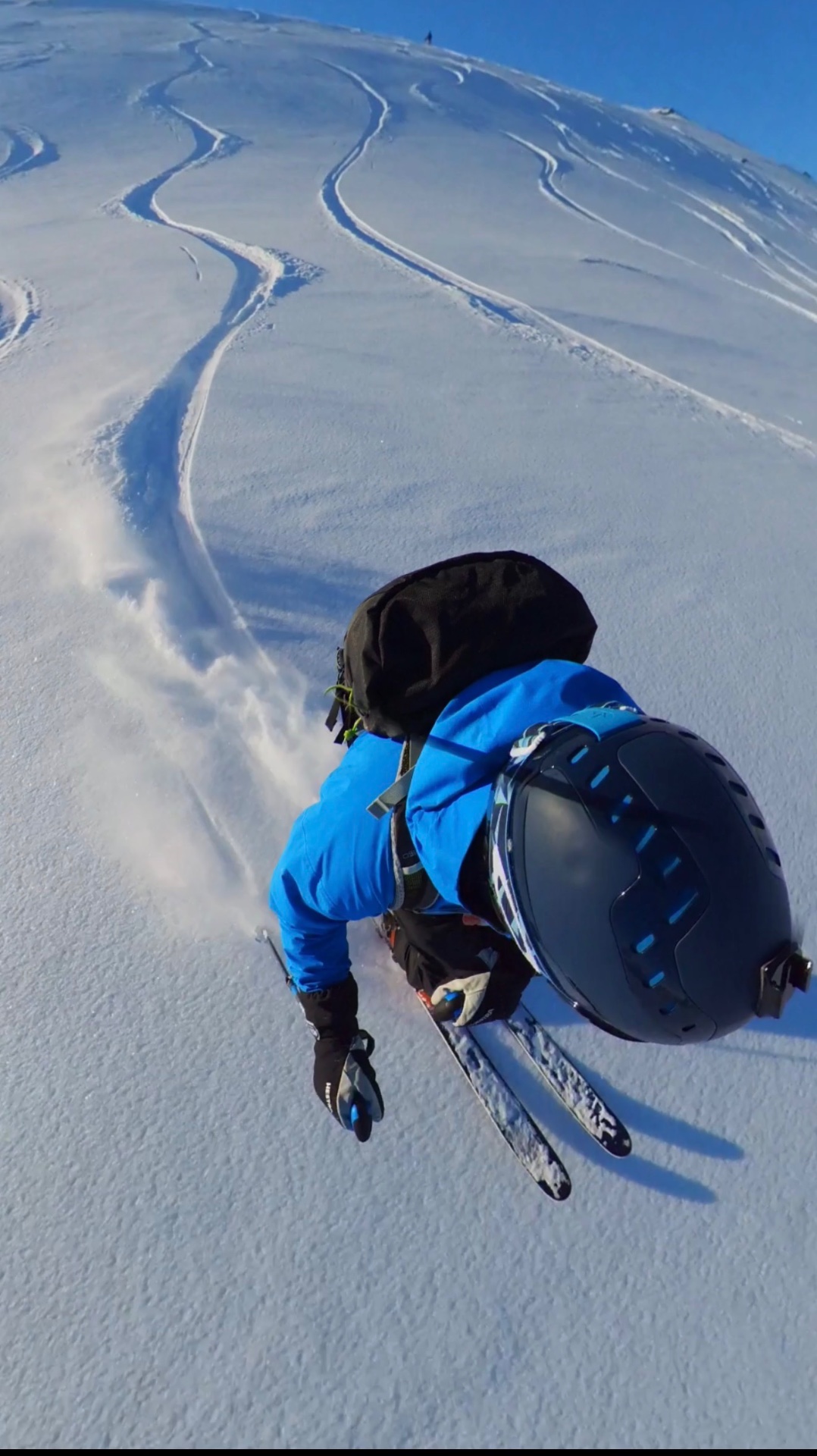 A skier on an open snow slope in Northern Norway