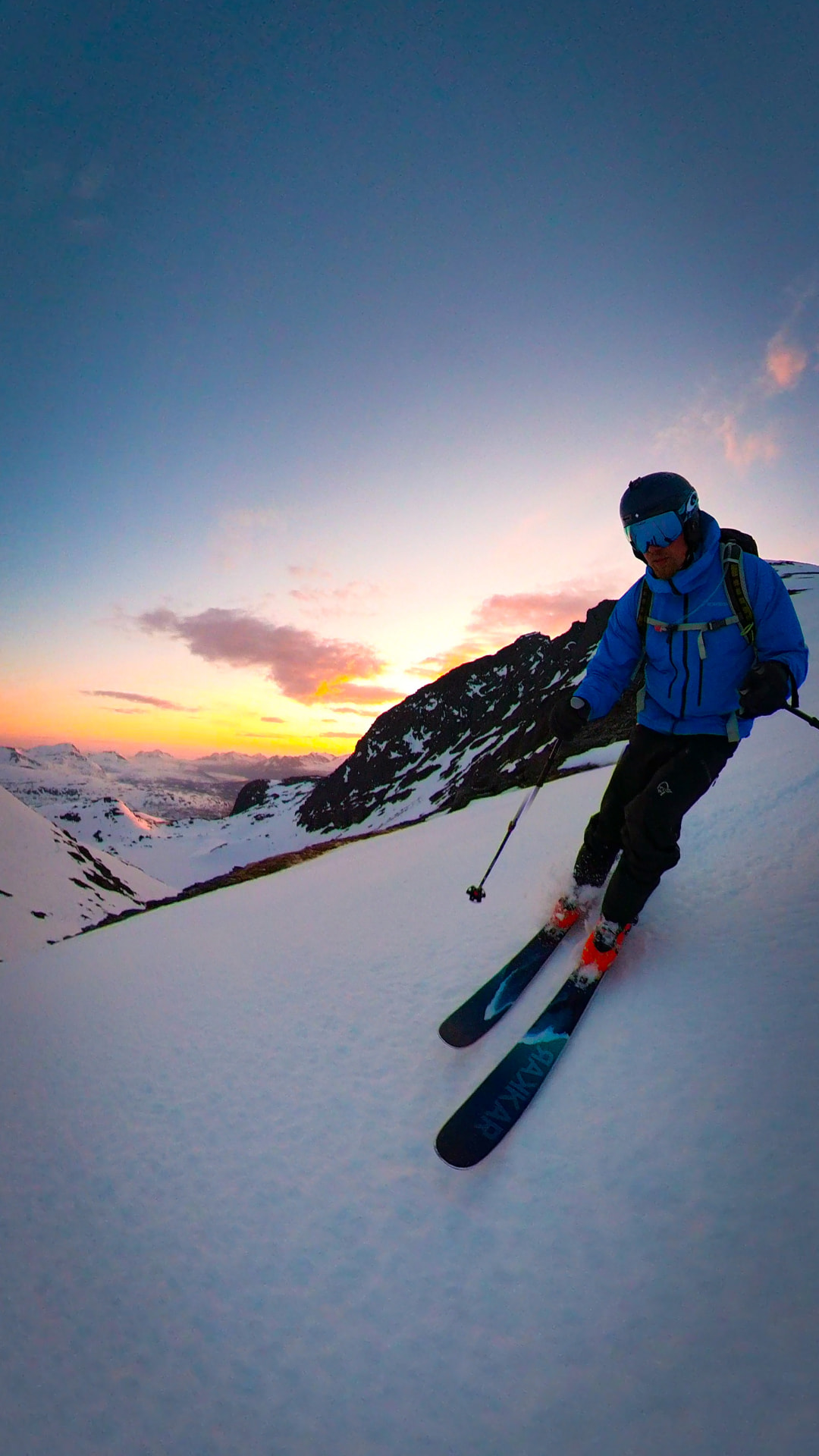 Ski touring up a snow-covered mountainside in Lavangen