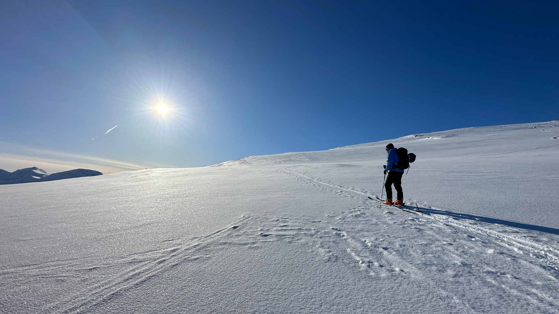 Skinning up a snow-covered slope on a spring day
